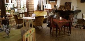 ein Zimmer mit Tischen und Stühlen und einem Kamin in der Unterkunft Austeria in Ostróda