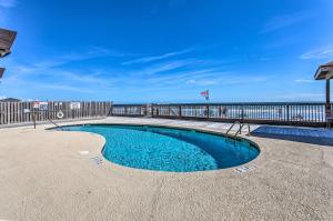 una piscina junto a un muelle con el océano en Beach Lovers Haven Oceanfront Condo with Pool!, en Myrtle Beach