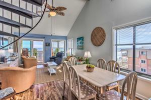 a dining room and living room with a table and chairs at Beach Lovers Haven Oceanfront Condo with Pool! in Myrtle Beach