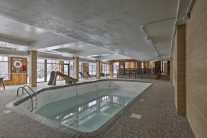 a large swimming pool in the middle of a building at Comfy Lutsen Mountain Villa with Balcony and Grill in Lutsen