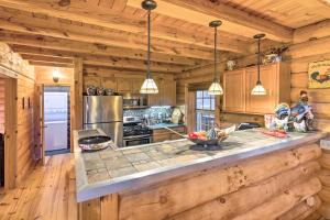 a kitchen with a counter top in a wooden cabin at Superb Linville Mountain Cabin with Wraparound Decks in Linville