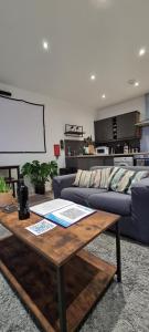 a living room with a table and a couch at Smart Town Centre Apartments in Northampton