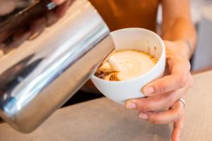 a person is holding a cup of coffee at Surfescape Fuerteventura in Lajares