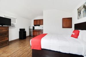 a hotel room with a bed and a kitchen at The Resource Inn -Big Lake TX in Big Lake
