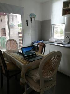 匹里亞波里斯的住宿－Descanso en Piriápolis，厨房里的一台笔记本电脑坐在桌子上