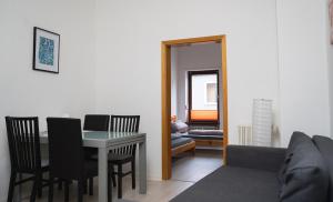 a living room with a table and chairs and a couch at 3 Zimmer Wohnung für max. 5 Personen in Alzey