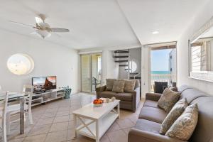 uma sala de estar com um sofá e uma mesa em Recently renovated! 3 beachfront balconies Beautiful and fully equipped condo em South Padre Island
