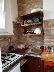 a kitchen with a sink and a stove top oven at Stefi Appartamento, Camera in Falconara Marittima