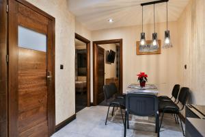 a dining room with a table and chairs and a door at Willa Śwarna I in Zakopane