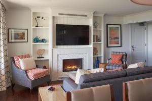 a living room with a couch and a fireplace at Inn By the Sea in Cape Elizabeth