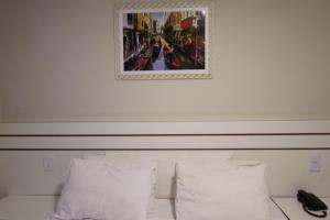 Postel nebo postele na pokoji v ubytování Pak Suítes Hotel