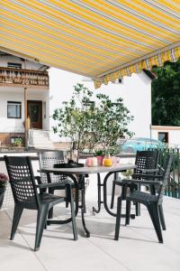 a table and chairs under an umbrella on a patio at Ferienwohnungen Schranz GbR in Heppenheim an der Bergstrasse