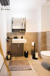 a bathroom with a sink and a mirror at Ferienwohnungen Schranz GbR in Heppenheim an der Bergstrasse +54 photos