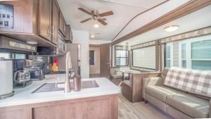 a kitchen and living room in a recreational vehicle at FunStays Glamping Destination RV Site 5 in Moab