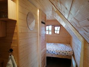 Cette petite chambre comprend un lit dans une cabane en rondins. dans l'établissement La Gare de Lurey Conflans gîte et hébergements insolites en Champagne, à Esclavolles-Lurey