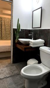 un bagno con un water bianco e un lavandino di Paziflora Hostel -STARLINK- a Puerto Escondido Altre 37 foto