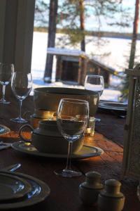 a wooden table with wine glasses on top of it at Chalet Norva in Rovaniemi +41 photos