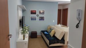 a living room with a couch and a sink at Paraíso Frente ao Mar in Barra Velha