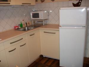 een keuken met een witte koelkast en een wastafel bij 3-х комнатная квартира в центре in Tsjerkasi