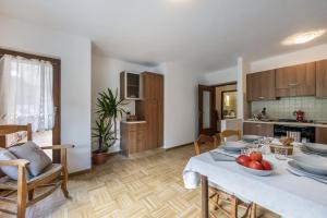 a kitchen and living room with a table with fruit on it at Agritur Broch in Fiera di Primiero