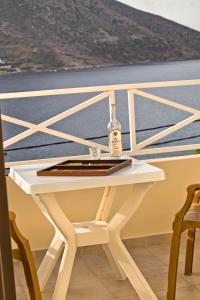 a bottle of wine sitting on a table on a boat at Acropolis Hotel in Masouri