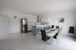 a kitchen with a table and chairs and a refrigerator at Villa Serpentona in Cala Galdana