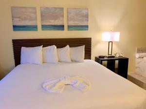 a large white bed with a ribbon on it at Seven Gables Inn in Branson