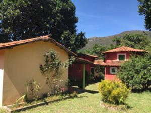 a house with a red and white house at Suite Raio de Sol in Vale do Capao +21 photos
