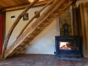 a wood stove in a room with a staircase at Apartman Jahorina Dolina mira in Pale