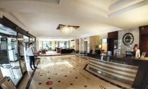 a man walking through a lobby of a building at Best Western Plus Hotel Konak in İzmir
