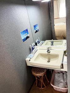 a bathroom with a sink and a mirror at Villa Rengatei in Hakuba