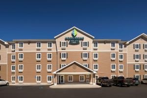 a large building with cars parked in front of it at WoodSpring Suites Hobbs in Air Base City