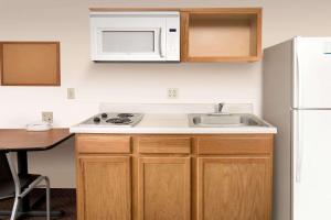 a small kitchen with a sink and a microwave at WoodSpring Suites Savannah Garden City in Savannah
