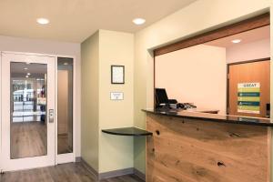 an office with a reception counter and a desk at WoodSpring Suites Raleigh Apex in Apex