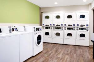 a laundry room with white washers and dryers at WoodSpring Suites Nashville Airport in Nashville