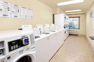 a laundry room with washers and dryers at WoodSpring Suites Baton Rouge East I-12 in Baton Rouge