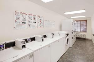 a laundry room with white washers and dryers at WoodSpring Suites Amarillo East I-40 in Amarillo