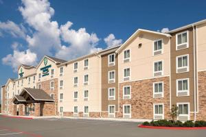 a rendering of the exterior of a building at Woodspring Suites Houston IAH Airport in Humble
