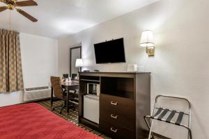 a hotel room with a bed and a flat screen tv at Econo Lodge La Junta in La Junta