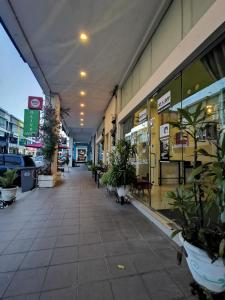 an empty hallway of a store with potted plants at Olive Hotel in Johor Bahru