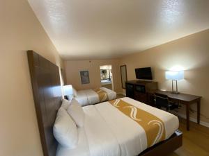 a hotel room with two beds and a television at Quality Inn in Pulaski