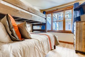 a bedroom with a bunk bed and a window at Estates on Galena #8 townhouse in Frisco