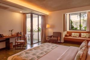Postel nebo postele na pokoji v ubytování Penh House Hotel
