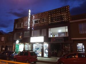 a building with cars parked in front of it at Hotel Paipa Inn in Paipa