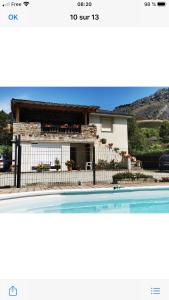 a house with a swimming pool in front of it at Au bord de l eau in Surba