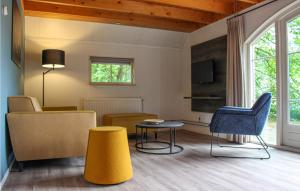 a living room with a couch and a table and chairs at Tsjep in De Bult