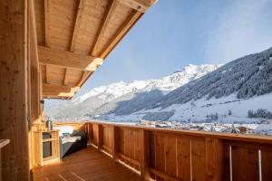 a room with a balcony with snow covered mountains at Luxury Naturperle Haus Alpenprinzessin helles Holzhaus zentral , modern & großräumig in Neustift im Stubaital