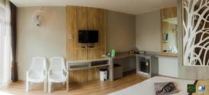 a living room with two white chairs and a desk at Ricci House Resort in Ko Lipe +197 photos