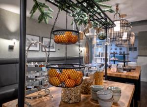a store with baskets of oranges on a table at Strandplevier Suites in De Koog