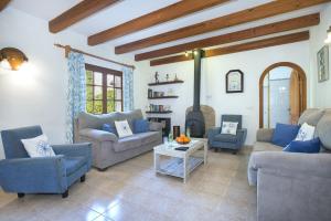 a living room with couches and a fire place at Owl Booking Villa La Font - Relax with a Big Pool in Pollença +32 photos
